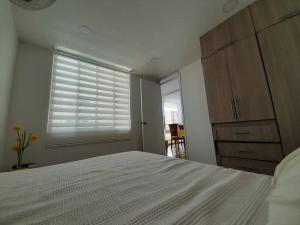 Ένα ή περισσότερα κρεβάτια σε δωμάτιο στο Apartamento en conjunto hacienda Peñaliza Limonar +16 φωτογραφίες