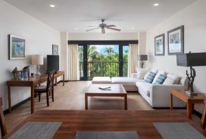 a living room with a white couch and a table at Wonderful 1-bed condo, 2min walk to beach & more in Bridgetown