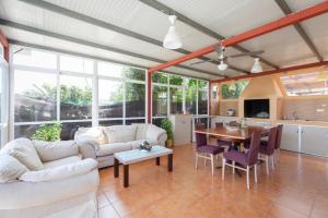 a living room with a couch and a table at Casita entre naranjas in Formentera de Segura