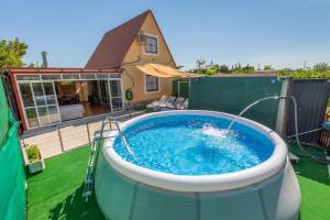 a large hot tub on the backyard of a house at Casita entre naranjas in Formentera de Segura