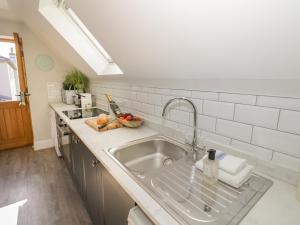 a kitchen with a sink and a counter at Coach House Mews in Stratford-upon-Avon