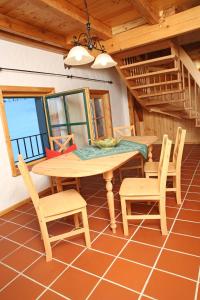 a dining room with a table and chairs in a house at Ober der Eller in Brotterode