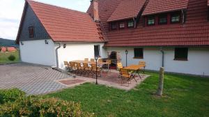 a house with a table and chairs in front of it at Ober der Eller in Brotterode