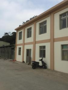 a motorcycle parked in front of a building at Home run Homestay in Dongyin