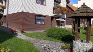 a house with a cross in the front yard at Apartmán 6 km od centra Banskej Bystrice in Banská Bystrica