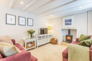 a living room with two couches and a fireplace at Beach Retreat in Bideford