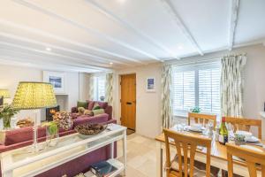 a living room with a table and a couch at Beach Retreat in Bideford