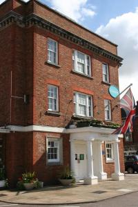 a brick building with a flag in front of it at The Broadway Hotel in Letchworth