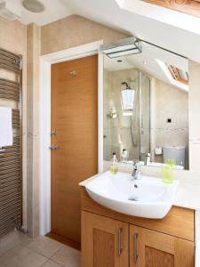 a bathroom with a sink and a mirror at 252 Aldeburgh Townhouse - Aldeburgh Coastal Cottages in Aldeburgh +5 photos