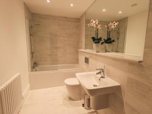 Un baño con inodoro, lavabo y ducha. en The Mary Maude Suite Stone Cross Mansion, en Ulverston 59 fotos más