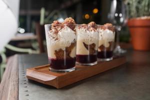 two desserts in glasses sitting on a wooden tray at The Canford in Poole