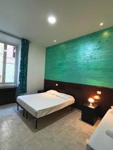 a bedroom with a bed and a large painting on the wall at Rome Termini Rooms 4 in Rome