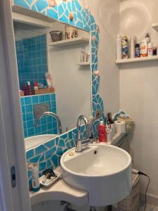 a bathroom with a sink and a mirror at Porto Coda Cavallo in San Teodoro