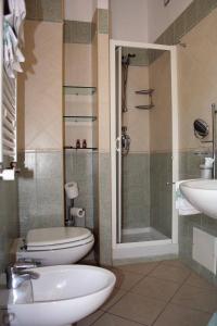 a bathroom with a toilet and a sink and a shower at Grazia Hotel in Sperlonga