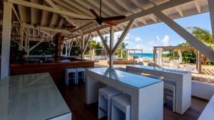 a restaurant with a view of the beach at Wyndham Tortola BVI Lambert Beach Resort in East End