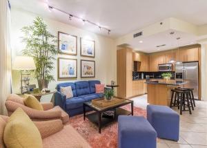 a living room with a blue couch and a kitchen at My Sapphire South Padre in South Padre Island