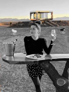 a woman sitting at a table with a plate of food at La Casa del Desierto in Gorafe