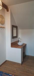 a bathroom with a sink and a mirror at La Bretonnière, Longère Picarde in Passel