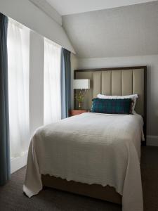 a bedroom with a large bed and a window at Marine Troon in Troon