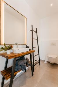 a bathroom with a sink and a mirror at Beyond Misty Cliffs in Scarborough