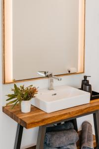a bathroom with a white sink and a mirror at Beyond Misty Cliffs in Scarborough