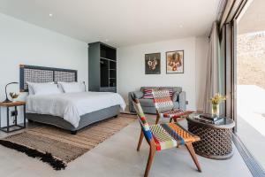 a bedroom with a bed and a chair and a couch at Beyond Misty Cliffs in Scarborough