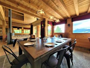 a dining room with a large wooden table and chairs at Chalet Les Gets, 8 pièces, 14 personnes - FR-1-598-27 in Les Gets