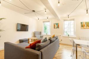 a living room with a couch and a table at Central, Bright 2 Bed Flat - Pool & Sauna in Edinburgh