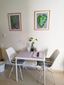 a dining room table with two chairs and a table at City Center Fresh Studio #Self Check In# in Thessaloniki