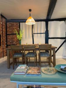 a dining room with a table and chairs and a lamp at Hideaway Holiday Apartment in Salisbury