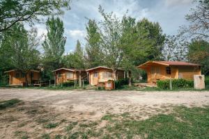 a group of cottages in the woods at Slow Life Camping Venta del Moro in Venta del Moro