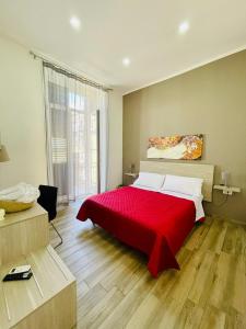 sypialnia z czerwonym łóżkiem i czerwonym kocem w obiekcie Dimora Centrale Home w mieście Napoli