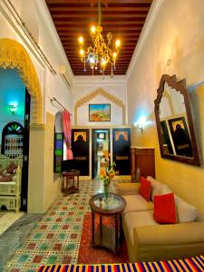 a living room with a couch and a table at Riad Baddi in Salé