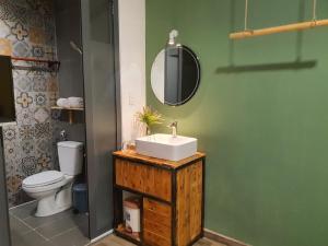 a bathroom with a sink and a toilet and a mirror at The 1- Tony saigon Hotel in Ho Chi Minh City +33 photos