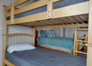 a bedroom with two bunk beds and a ladder at Harbour Village Retreat in Garden City
