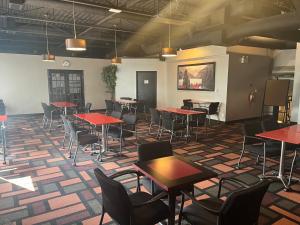 a room with tables and chairs in a building at Super 8 by Wyndham Macleod Trail Calgary in Calgary