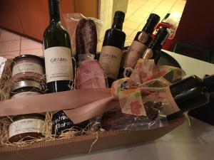 a basket of wine and meats on a counter at SternenHimmel - Romantik Zimmer !klimatisiert! in Gamlitz