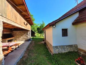 une grange avec une table de pique-nique à côté d'un bâtiment dans l'établissement Etno guest house Lalovic, à Tjentište