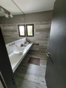ein Badezimmer mit einem weißen Waschbecken und einem Spiegel in der Unterkunft Duplex de Categoria - con estacionamiento gratuito in Cordoba + 21 Fotos