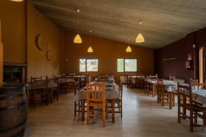 a dining room with tables and chairs and lights at Slow Life Camping Venta del Moro in Venta del Moro