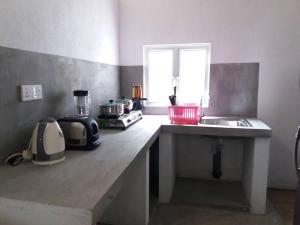 a kitchen with a counter top with a appliance on it at Villa Four Seasons in Mirissa