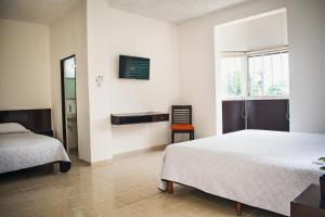 Postel nebo postele na pokoji v ubytování Hotel Cupules