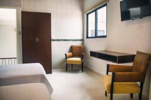 Postel nebo postele na pokoji v ubytování Hotel Cupules