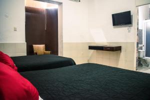 Postel nebo postele na pokoji v ubytování Hotel Cupules