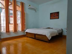 a bedroom with a bed and two windows at HOTEL GANGA VIEW harry stay in Shivpuri