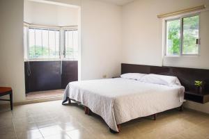 Postel nebo postele na pokoji v ubytování Hotel Cupules