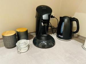 a black coffee maker sitting on top of a counter at Hell, gemütlich, zentral - Appartement am Dom in Braunschweig