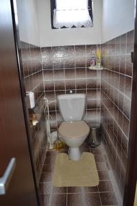 a small bathroom with a toilet and a window at Penzion243 in Tábor +10 photos