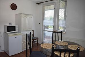 a kitchen with a table and chairs and a microwave at Penzion243 in Tábor