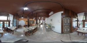 a large room with tables and chairs in a building at Quari Quara BY MN Hotéis in Rio das Ostras